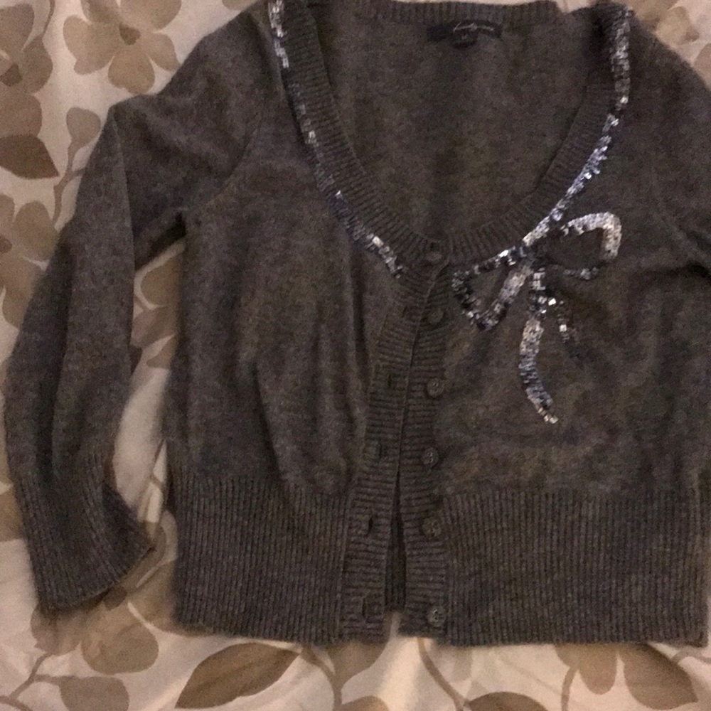 Grey sweater with sequence bow . Worn once